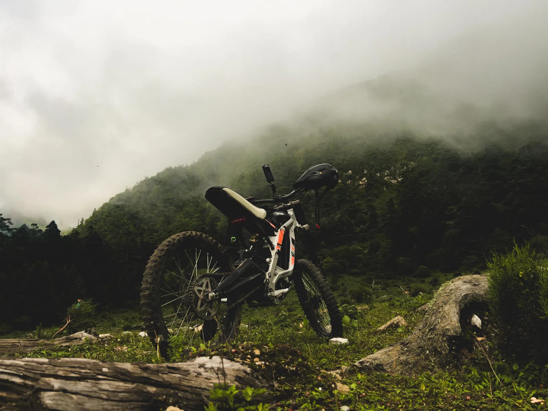 Mountain bike resting on a fog-covered trail