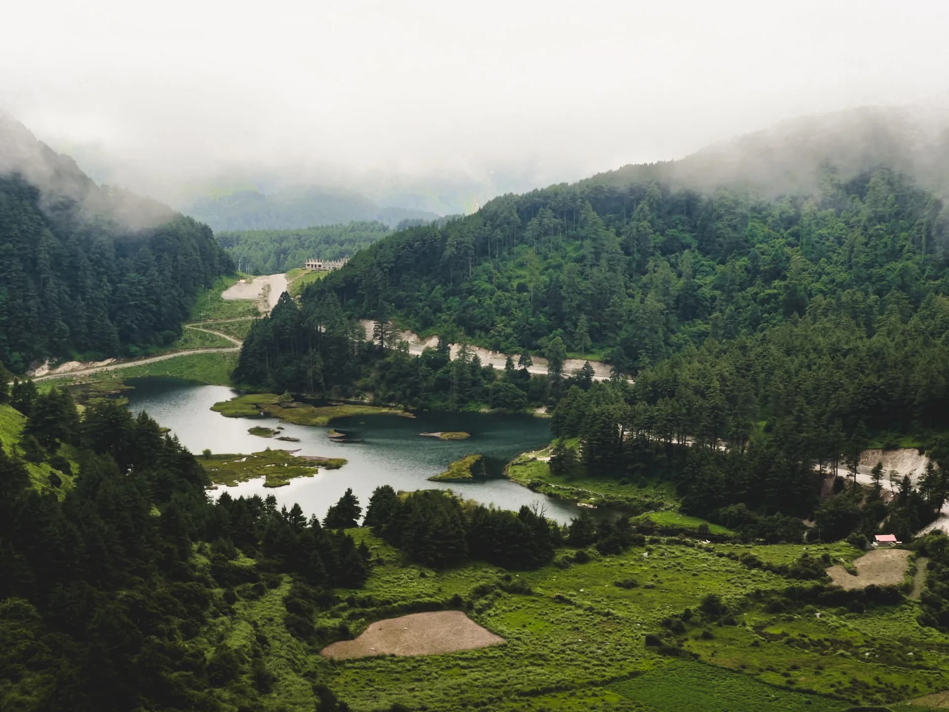 River winding through a misty forested valley