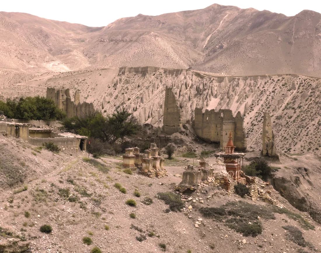 Ruined chortens and fortress walls on a barren Upper Mustang hillside